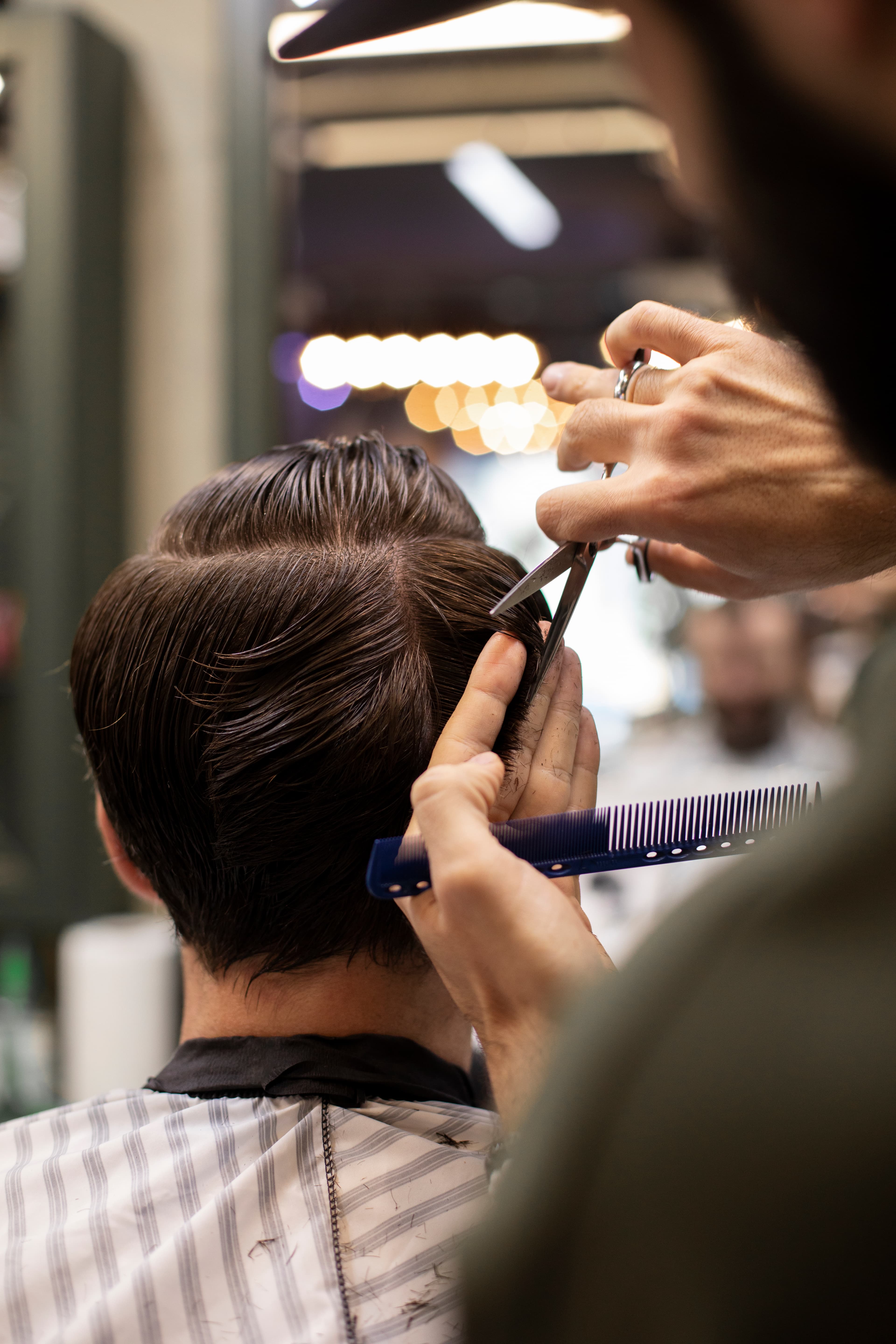 Stylist working on client's hair